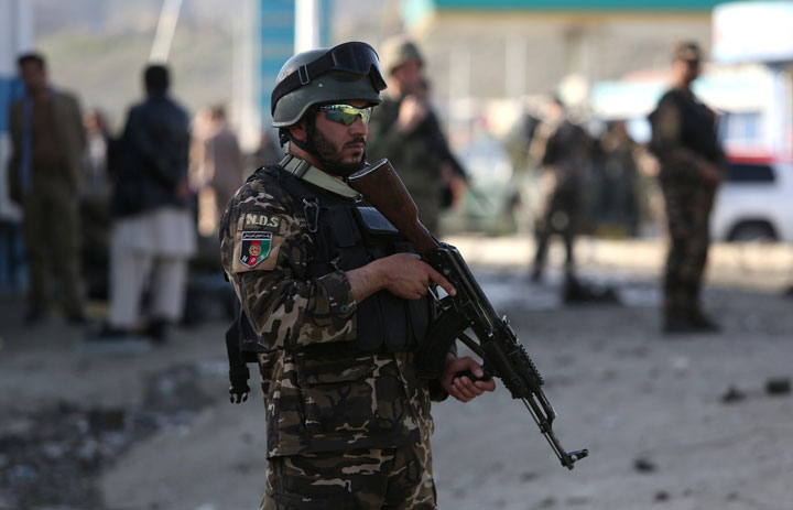 Afghan security personnel gather at the site of a suicide attack in Kabul, Afghanistan, Friday, April, 10, 2015. 