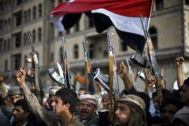 Shiite rebels, known as Houthis, hold up their weapons as they attend a protest against Saudi-led airstrikes in Sanaa, Yemen, Friday, April 10, 2015.