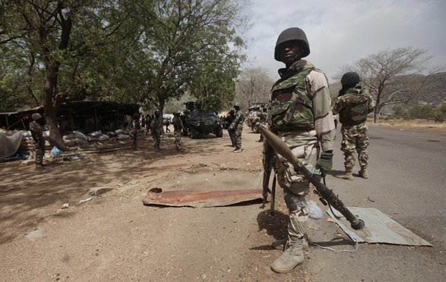  In this file photo taken Wednesday, April 8, 2015, Nigerian Soldiers man a check point in Gwoza, Nigeria, a town newly liberated from Boko Haram. 