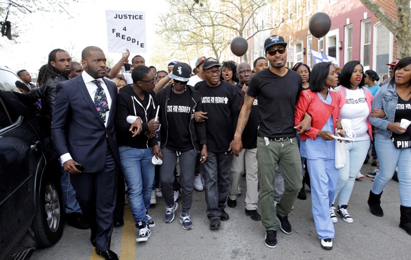 Supporters and family members of Freddie Gray lead a march to the Baltimore Police Department’s Western District police station during a vigil for Freddie Gray, Tuesday, April 21, 2015, in Baltimore. Gray died from spinal injuries a week after he was arrested and transported in a police van.