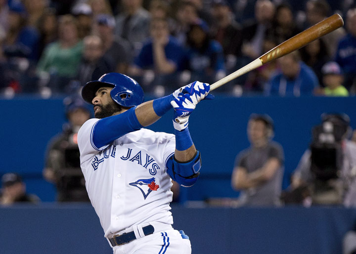Toronto Blue Jays right fielder Jose Bautista, watches his two run home run against the Tampa Bay Rays during first inning AL baseball action in Toronto on Wednesday, April 15, 2015.