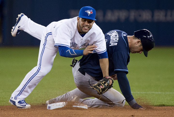 Toronto Blue Jays second baseman Devon Travis, left, forces out Tampa Bay Rays Evan Longoria, right, at second base but can not turn over the double play during sixth inning AL baseball action in Toronto on Tuesday, April 14, 2015.
