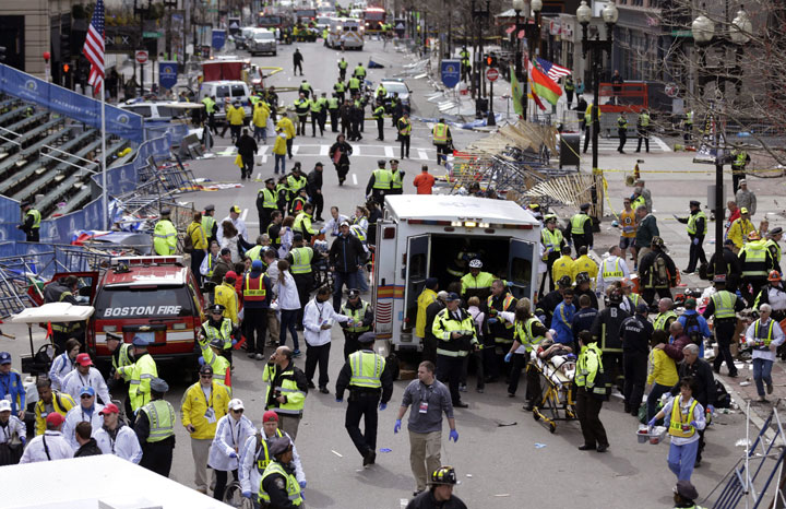 In this April 15, 2013, file photo, medical workers aid injured people following an explosion at the finish line of the 2013 Boston Marathon in Boston.