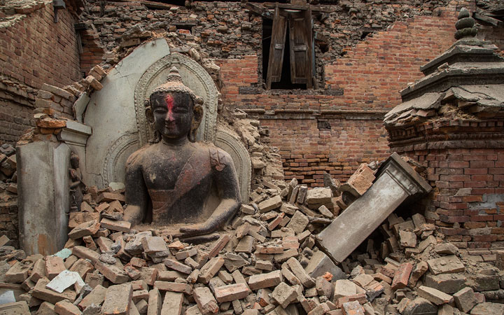   A Buddha statue is surrounded by debris from a collapsed temple in the UNESCO world heritage site of Bhaktapur on April 26, 2015 in Bhaktapur, Nepal. 