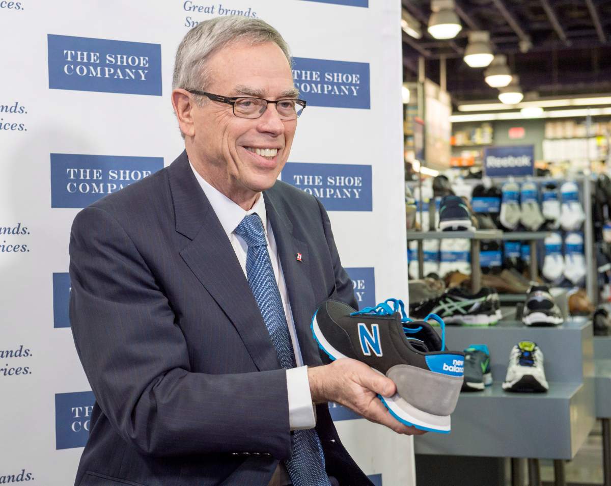 Federal Finance Minister Joe Oliver shows off his new budget shoes during a photo op in Toronto on Monday, April 20, 2015.