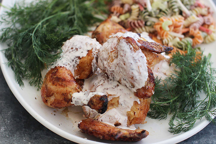 This March 23 2015 photo shows butterflied barbecue chicken with Alabama white sauce in Concord, N.H.