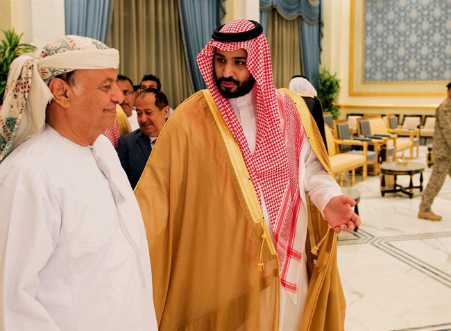 FILE – In this Thursday, March 26, 2015 file photo, provided by the Saudi Press Agency (SPA), Yemen’s President Abed Rabbo Mansour Hadi, left, walks with Saudi Defense Minister Mohammed bin Salman as Hadi arrives in Riyadh, Saudi Arabia.