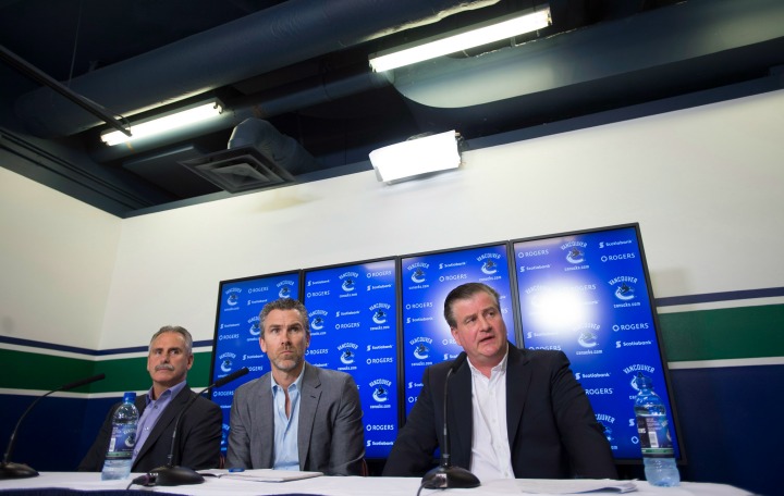 Vancouver Canucks general manager Jim Benning, right to left, President of Hockey Operations Trevor Linden and Head Coach Willie Desjardins attend a news conference at Rogers Arena in Vancouver, B.C. Wednesday, April 29, 2015. 