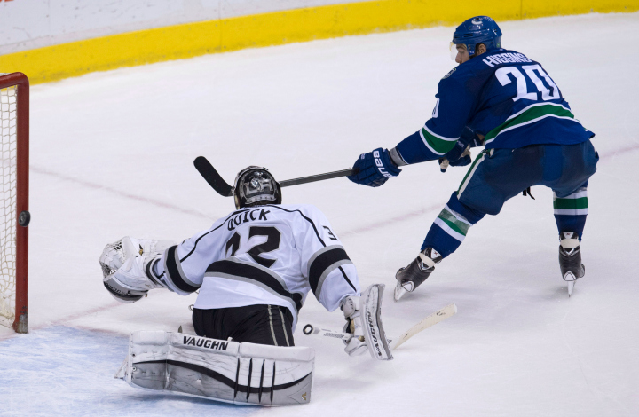 Vancouver Canucks left wing Chris Higgins (20) sends his game winning shoot out shot past Los Angeles Kings goalie Jonathan Quick (32) in Vancouver, B.C. Monday, April 6, 2015. 