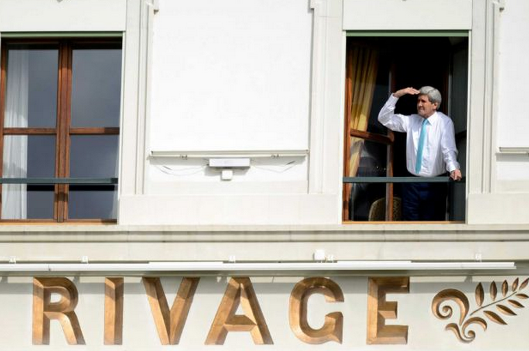 US Secretary of State John Kerry looks at the view of Lake Geneva from his hotel room as the Iran nuclear talks continue in Lausanne, Switzerland, Wednesday, April 1, 2015. Negotiations over Iran's nuclear program resumed Wednesday but were almost immediately beset by competing claims, just hours after diplomats abandoned a March 31 deadline to reach the outline of a deal and agreeing to press on.