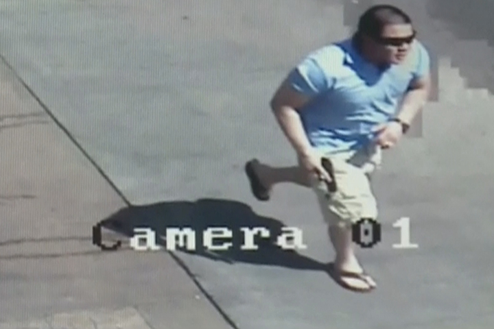 Surveillance camera shows Smyrna,Georgia city employee chasing after car with his gun drawn.