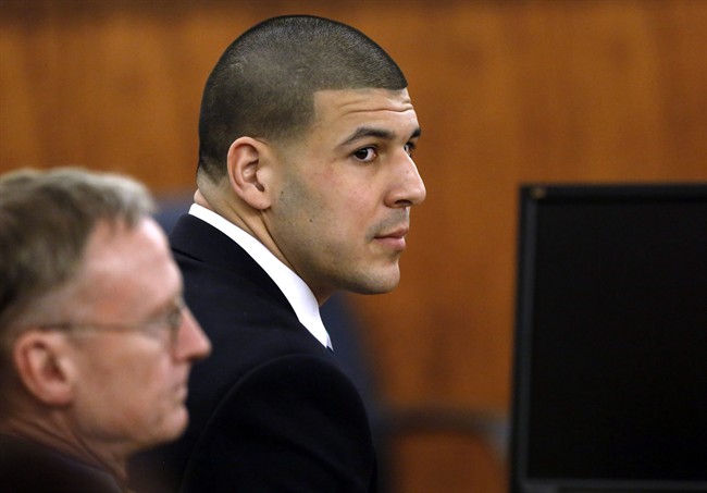 Former New England Patriots football player Aaron Hernandez, right, sits with defense attorney Charles Rankin, left.