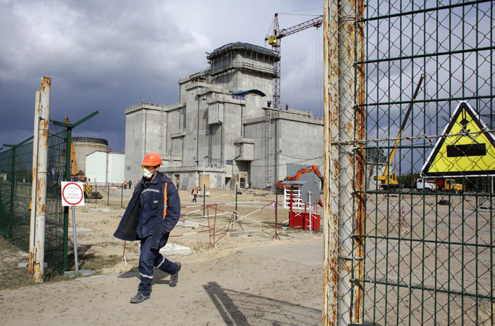 A worker walks past a construction site for a spent nuclear-fuel storage facility next to the Chernobyl Nuclear Power plant, on April 21, 2015. 