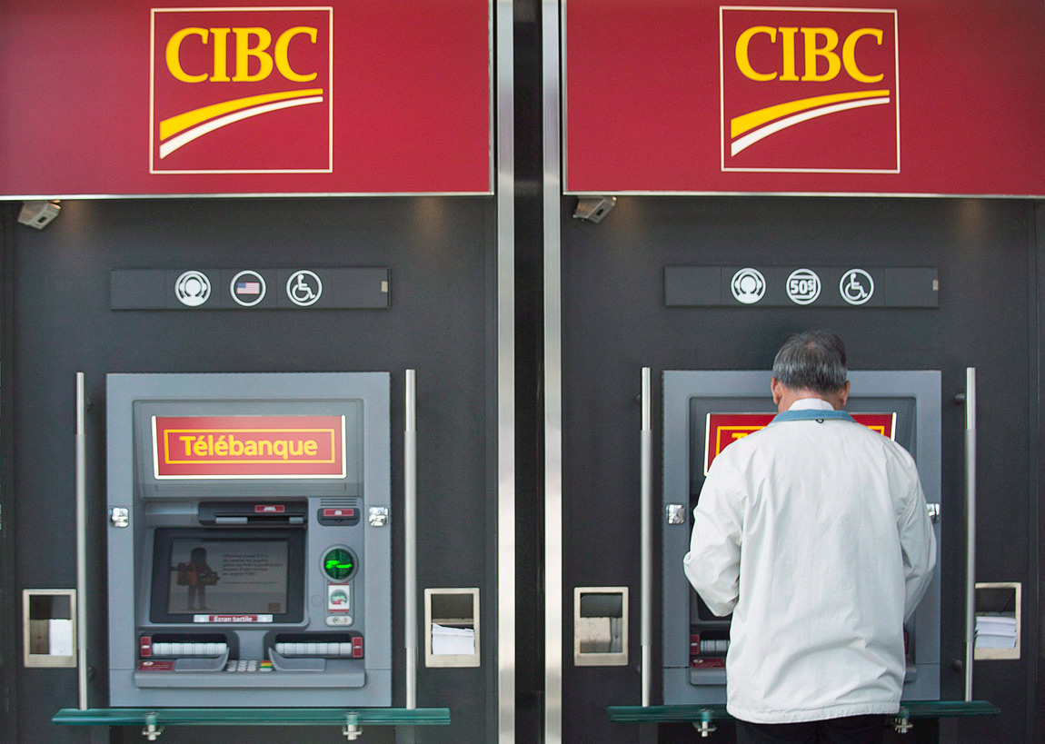 A man uses an ATM at a CIBC branch in Montreal, on April 24, 2014.