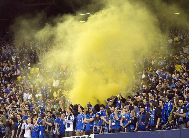 Montreal Impact fans let off smoke bombs during their team's 2-0 win over LD Alajuelense during the first leg of the CONCACAF semi-final soccer action Wednesday, March 18, 2015 in Montreal.