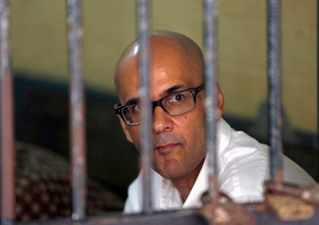 Canadian teacher Neil Bantleman sits inside a holding cell prior to the start of his trial hearing to listen to the prosecutor's demand at South Jakarta District Court in Jakarta, Indonesia, March 12, 2015.