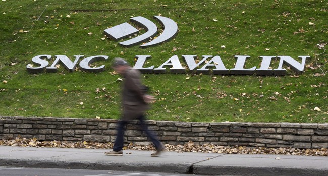 A man walks past the headquarters of SNC-Lavalin in Montreal on November 6, 2014.