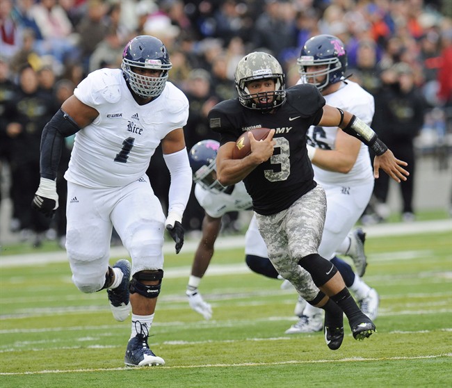 Rice defensive tackle Christian Covington (1) chases Army quarterback Angel Santiago (3) during the first half of an NCAA college football game in West Point, N.Y., on Oct. 11, 2014. Grover Covington terrorized CFL quarterbacks over his 11-year career, registering a league-record 157 sacks as a defensive end with the Hamilton Tiger-Cats.
