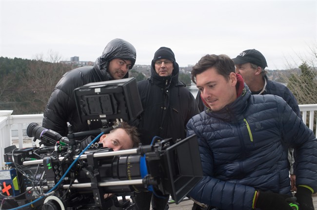 Halifax-based camera operator Andrew Stretch, right in blue jacket, and other crew on the set of Haven, a supernatural drama filmed in Nova Scotia.