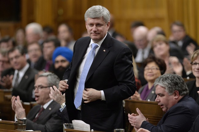 Harper is shown rising to vote in the House of Commons on Parliament Hill in Ottawa, Monday March 30, 2015.
