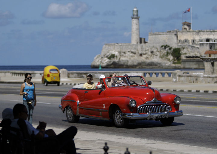 Tourists ride in a classic American car on the Malecon in Havana, Cuba. A new set of U.S. government regulations took effect  Jan. 16, 2015, severely loosening the 50-decade long travel and trade restrictions for Cuba.