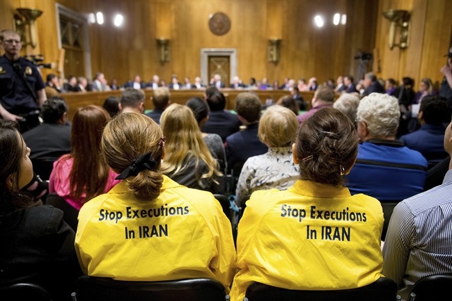 Protestors sit in the audience during a Senate Foreign Relations Committee business meeting to debate and vote on S.615, the Iran Nuclear Agreement Review Act of 2015 on Capitol Hill in Washington, Tuesday, April 14, 2015. Republican and Democrats on the Senate Foreign Relations Committee reached a compromise Tuesday on a bill that would give Congress a say on an emerging deal to curb Iran's nuclear program.