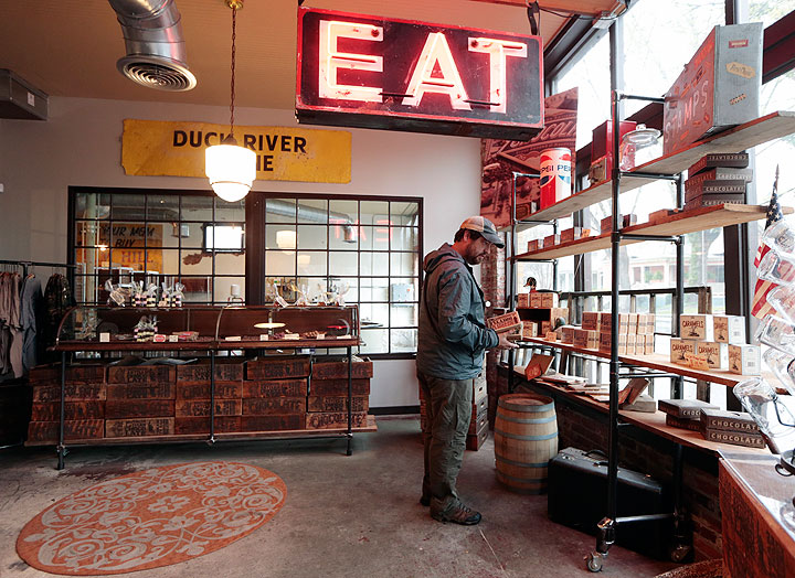 In this April 6, 2015, photo, Rick Russell shops at Olive and Sinclair Chocolate in the East Nashville area of Nashville, Tenn. The East Nashville neighborhood houses an eclectic collection of restaurants, bars, coffee shops, bakeries and stores, mixed into a residential area of 1950s and 1960s homes.