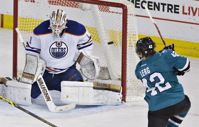 San Jose Sharks Bryan Lerg (42) scores a goal on Edmonton Oilers goalie Laurent Brossoit (1) during third period NHL hockey action in Edmonton, Alta., on Thursday April 9, 2015. 
