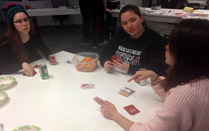 Nicolette Bertsch explains the Exploding Kittens game at a playtest party on April 9, 2015 in Toronto.