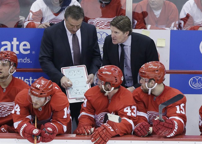Detroit Red Wings head coach Mike Babcock right, talks to the team as assistant Andrew Brewer draws up a plan during the third period of Game 6 of a first-round NHL Stanley Cup hockey playoff series, Monday, April 27, 2015 in Detroit. Babcock hinted his future may lie elsewhere after the Red Wings were eliminated from the playoffs.