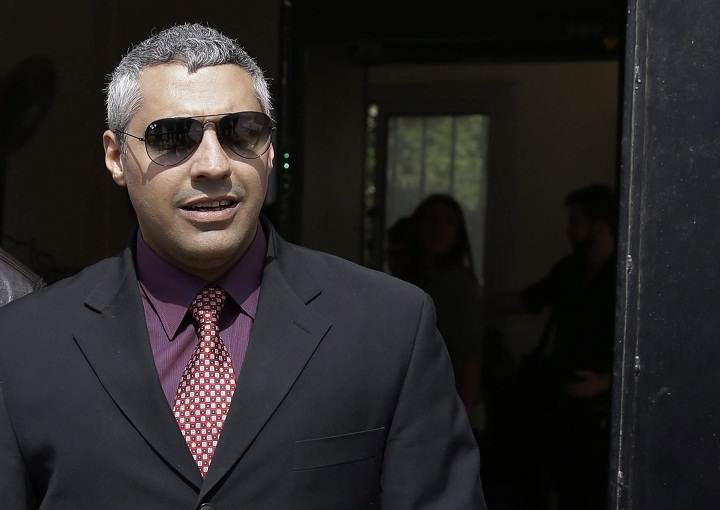 Al Jazeera English journalist Canadian Mohamed Fahmy leaves court after a hearing in the retrial near Tora prison in Cairo, Egypt, Sunday, March 8, 2015.