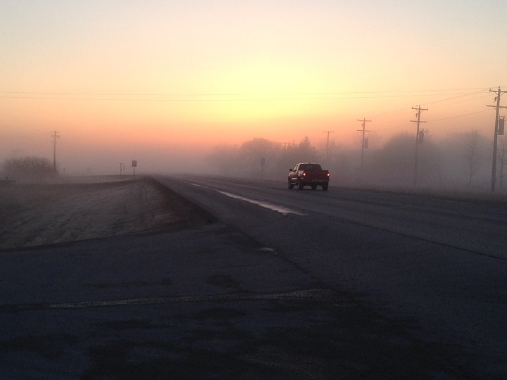 The fog sets in as the sun rises over McGillivray Blvd near McCreary Rd.