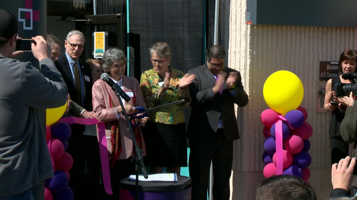 Judith Umbach cutting the ribbon at the official re-opening of the renovated library Sunday. The Thorn-Hill Library has since been named after her. 
