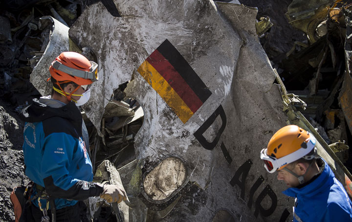 In this photo taken on Tuesday, March 31, 2015 and provided by the French Interior Ministry, French emergency rescue services work among debris of the Germanwings passenger jet at the crash site near Seyne-les-Alpes, France. 