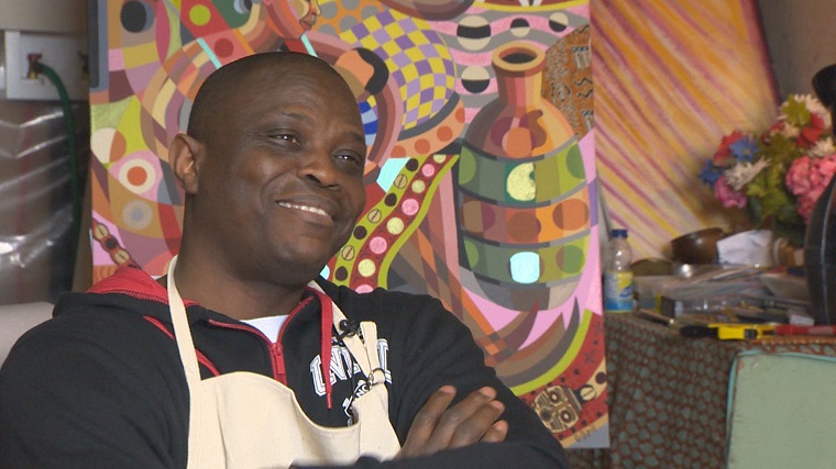 Gibril Bangura says his "Happy Paintings" started as a form a therapy. Now he's hoping they help others.