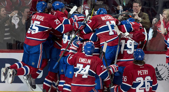 Members of the Montreal Canadiens pile up onto teammate Alex Galchenyuk following his winning goal over the Ottawa Senators during first period overtime of Game 2 NHL Stanley Cup first round playoff hockey action Friday, April 17, 2015 in Montreal. The Canadiens beat the Senators 3-2 to take a 2-0 lead in the best-of-seven series.