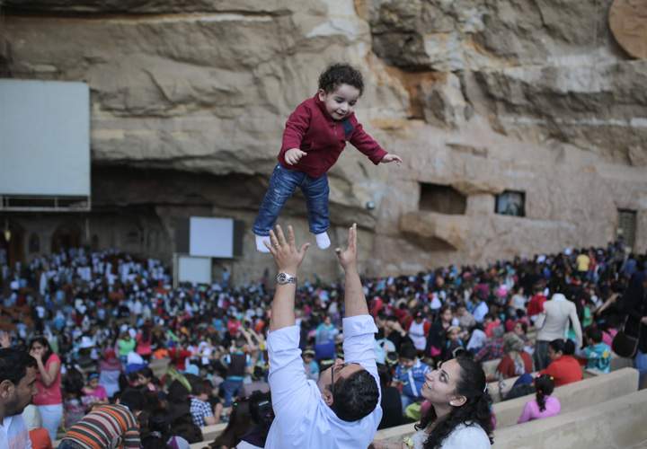 Egyptian Orthodox Christians celebrate Palm Sunday during a service in the Samaan el-Kharaz Church in the Mokattam district of Cairo, Egypt, Sunday, April 5, 2015. Western Christian churches and most Orthodox Christian churches follow different calendars and observe Easter on different dates.