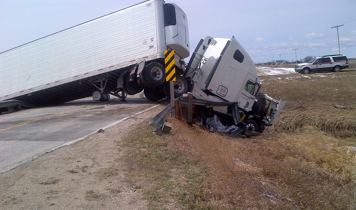 Hwy 15 just east of Winnipeg was closed Tuesday after a tractor-trailer crashed and was left hanging over a bridge.