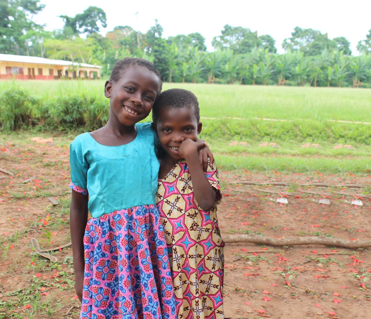 Children smiling for the camera in the first community.