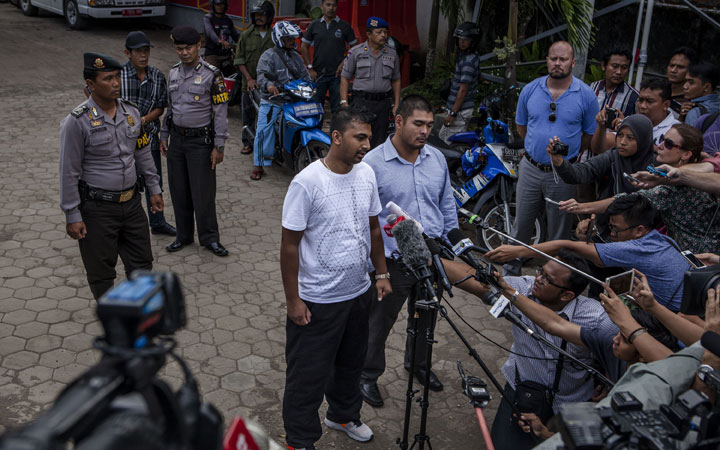 Chinthu Sukumaran (L) and Michael Chan (R), the brothers of Australian death row prisoners Andrew Chan and Myuran Sukumaran, talk to journalists at Wijaya Pura port after visiting their brothers at Nusakambangan prison on April 26, 2015 in Cilacap, Central Java, Indonesia.