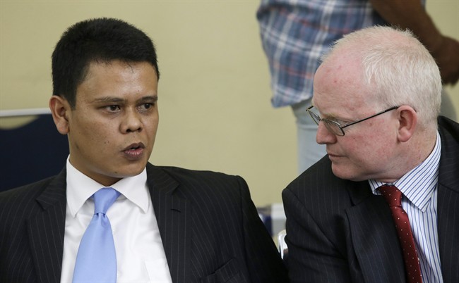 Leonard Arphan, left, and Julian McMahon, lawyers of two Australians on death row Myuran Sukumaran and Andrew Chan, confer each other during a hearing at the High Administrative Court in Jakarta, Indonesia, Monday, April 6, 2015. The court rejected appeals by the two drug traffickers trying to avoid their executions.