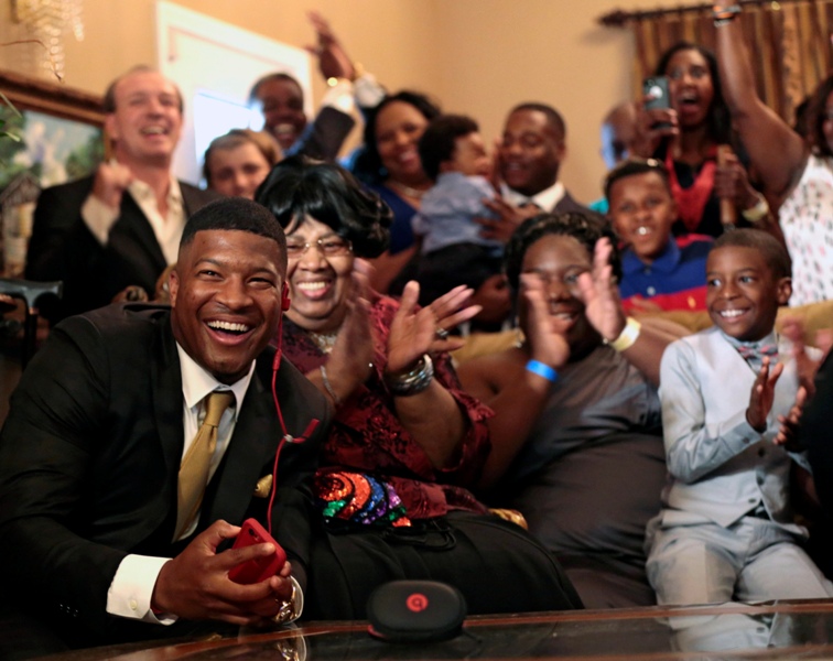 Jameis Winston reacts with his family and friends as he takes the call from the Tampa Bay Buccaneers that they are selecting him as the number one draft pick, Thursday, April 30, 2015, in Bessemer, Ala. 