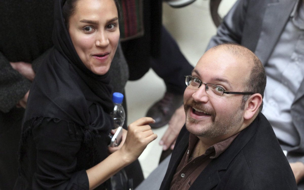 Jason Rezaian of The Washington Post and his wife Yeganeh Salehi, smile as they attend a presidential campaign of President Hassan Rouhani in Tehran, Iran on April 11, 2013.