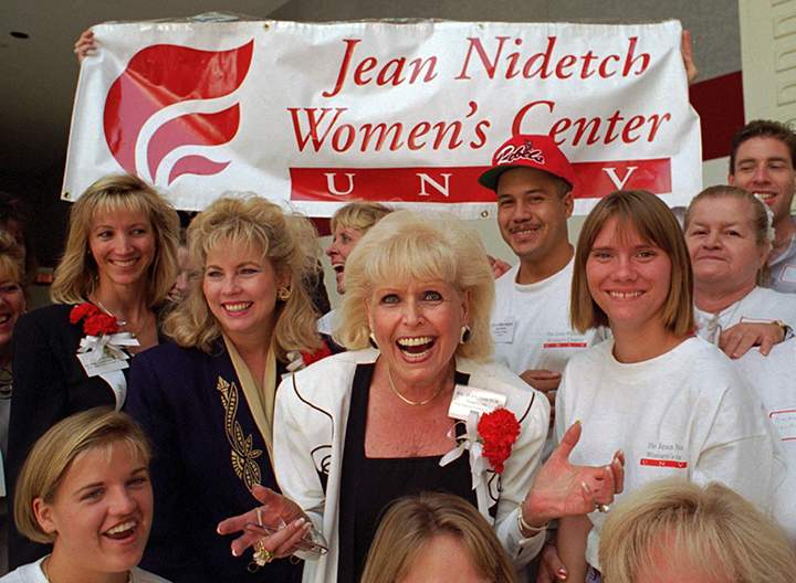 In this Sept. 9, 1995, file photo, Jean Nidetch, center, founder of Weight Watchers International, reacts with a group of workers from the Jean Nidetch Women’s Center during a Jobs Fair on the campus of the University of Nevada at Las Vegas in Las Vegas.