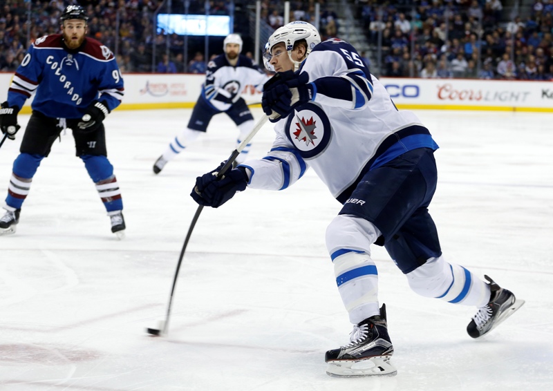 Winnipeg Jets center Mark Scheifele takes a shot on goal against the Colorado Avalanche during the second period of an NHL hockey game, Thursday, April 9, 2015, in Denver. 