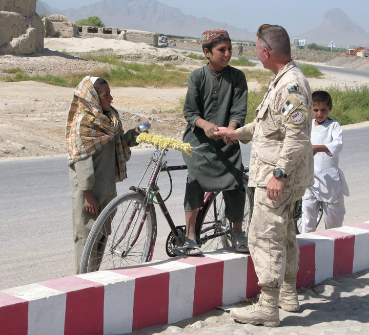 Jonathan Vance greets children during a visit to the NATO model village in the Dand district, south of Kandahar, Afghanistan, in this Sept. 10, 2009 photo.