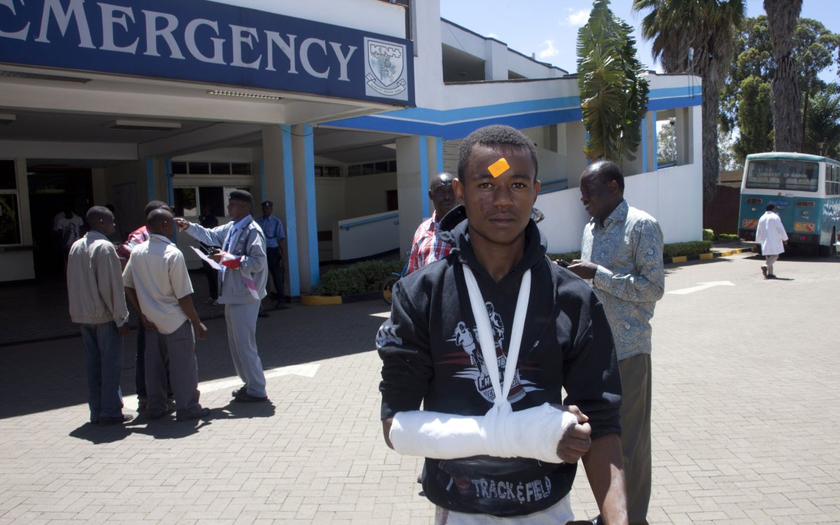 A university student with a broken arm in plaster leaves Kenyatta National Hospital, Sunday, April 12, 2015, in Nairobi, Kenya.