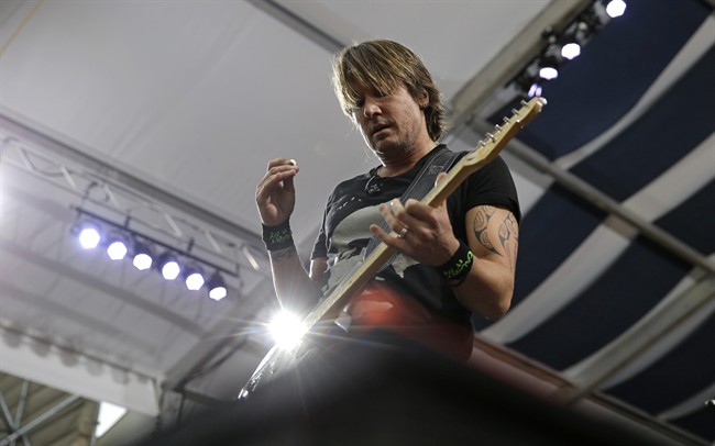 Country music artist Keith Urban performs at the New Orleans Jazz and Heritage Festival in New Orleans, Friday, April 24, 2015. 