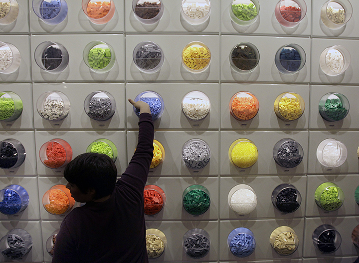 A boy reaches for a Lego piece on the pick-a-brick wall at a U.S. store.