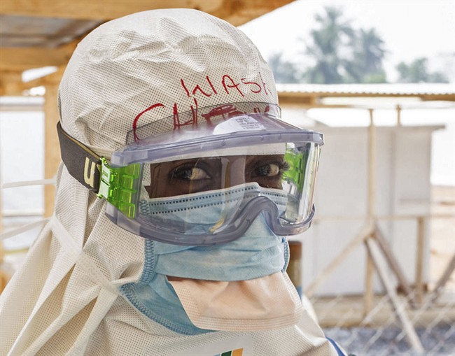 In this file photo taken on Monday, March 2, 2015, a health care worker is seen at an Ebola virus clinic in Makeni, Sierra Leone. 